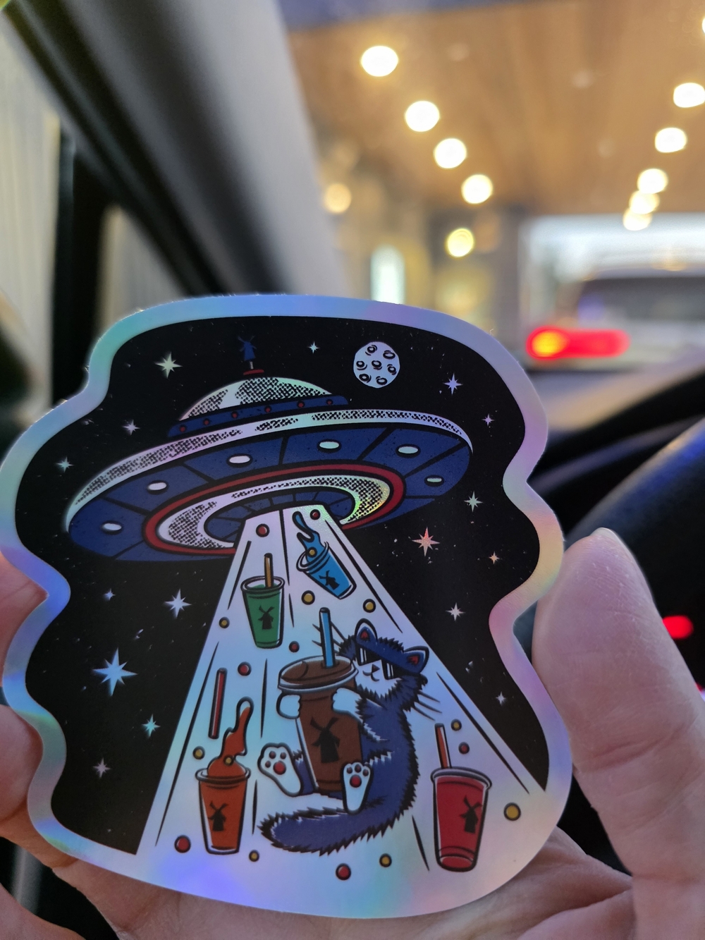 DUTCH BROS Alien UFO Raccoon Holographic Sticker - Black Background